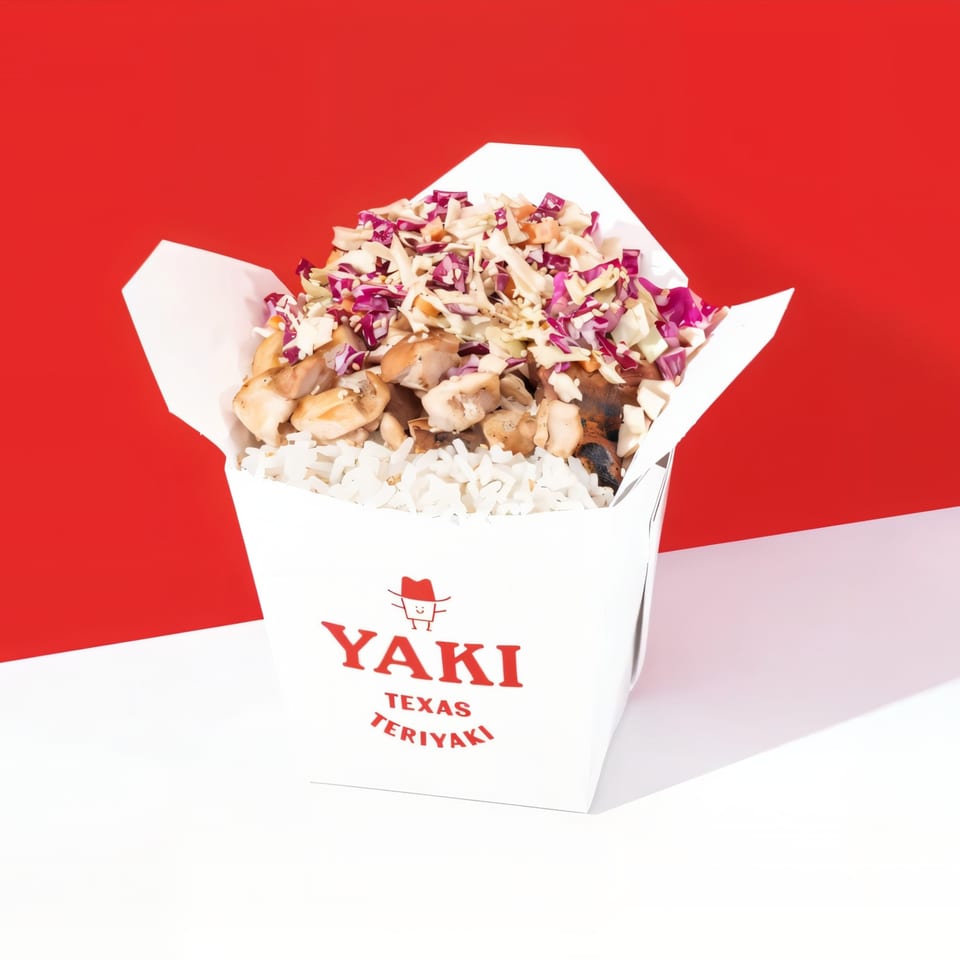 Yaki Texas Teriyaki box filled with white rice, chicken, and purple and white cabbage.